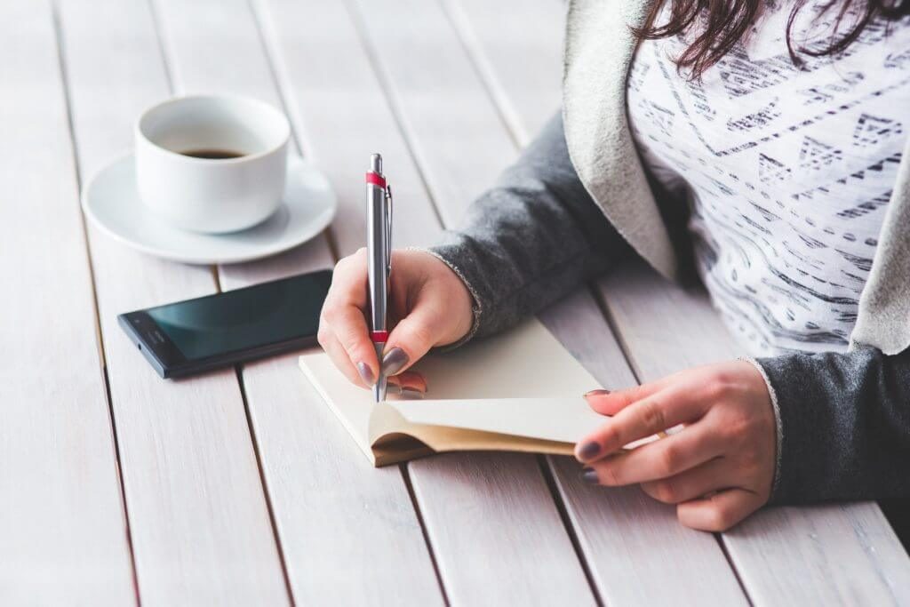 woman-journaling for blog post how to know God's plan for your next steps as an entrepreneur