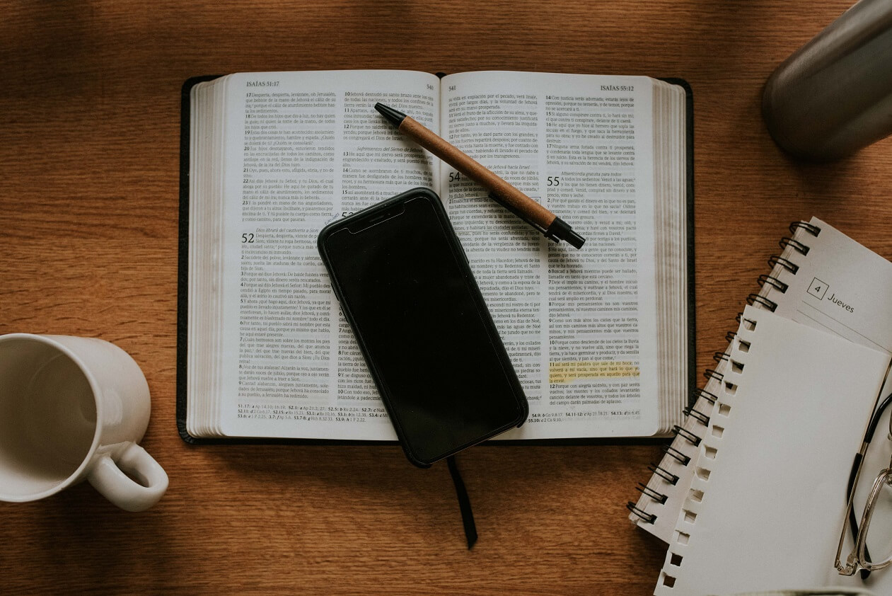 Bible, phone, pen and notebook to help you find your word of the year