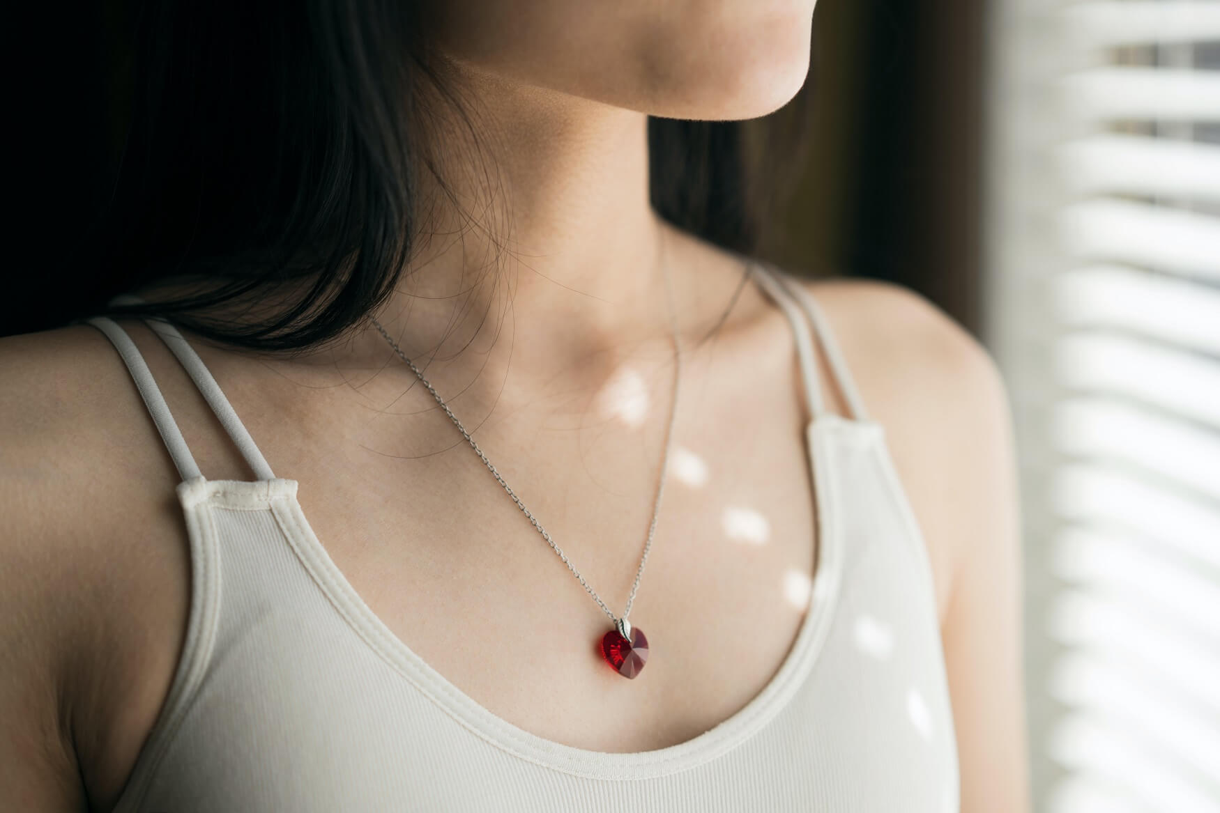 woman wearing a heart necklace