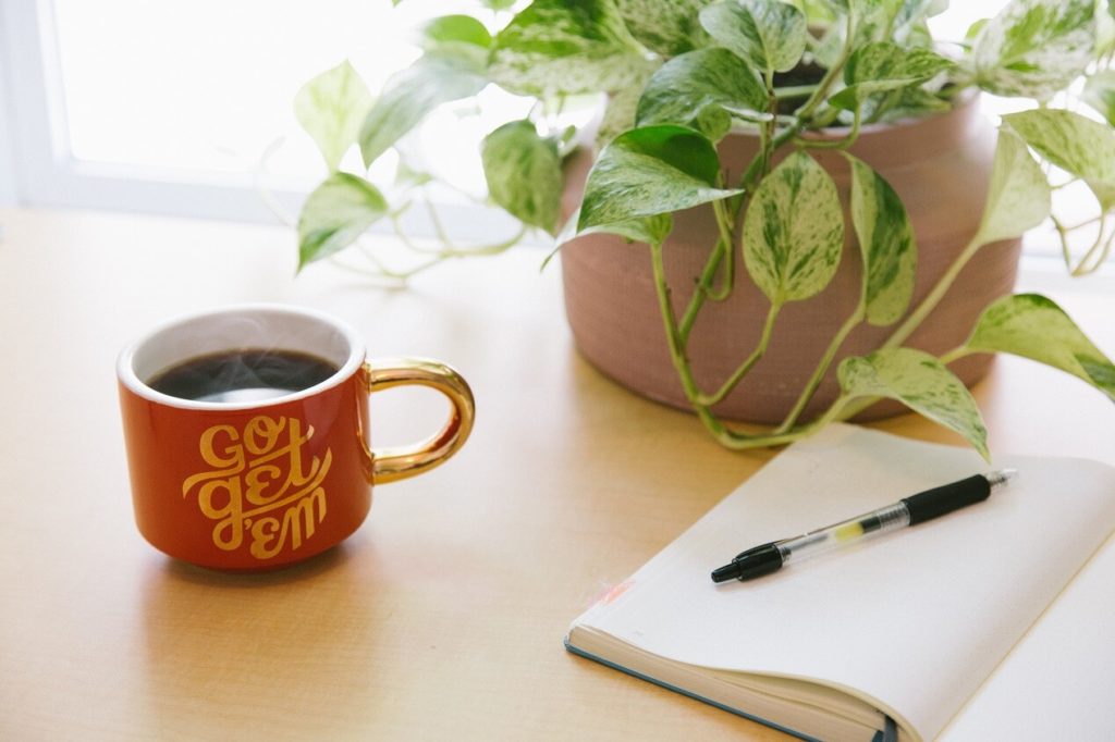 Image of a coffee mug with words GO GET'EM written on for blog post how to avoid distractions and stay focused 