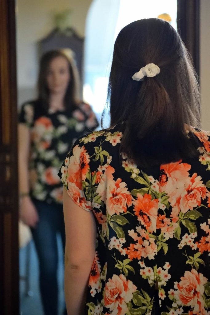 woman seeing reflection in mirror to show focusing on Your Ideal Client Profile. For blog post Who is God calling you to serve?