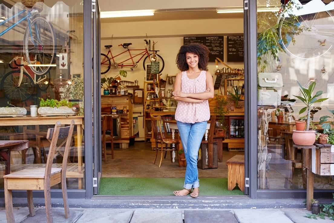 stay motivated in your God-centered business -Woman in front of her shop