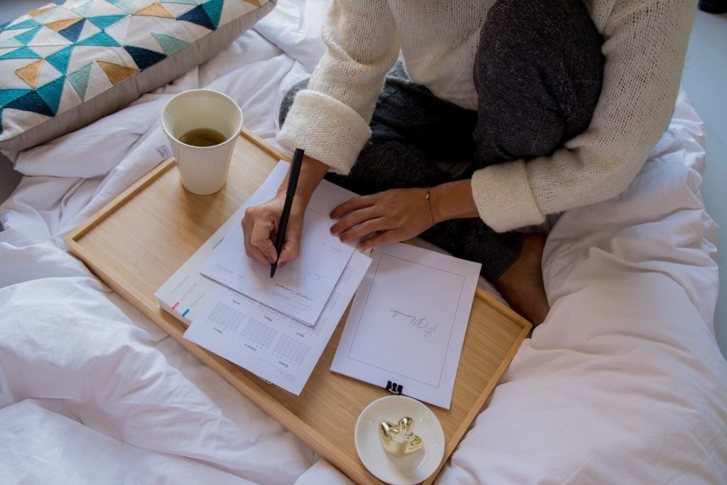 woman planning her day on paper planner