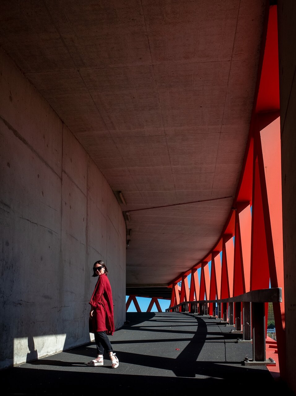 Choosing the Right Path When in Transition woman in red coat walking on path inside a parking structure