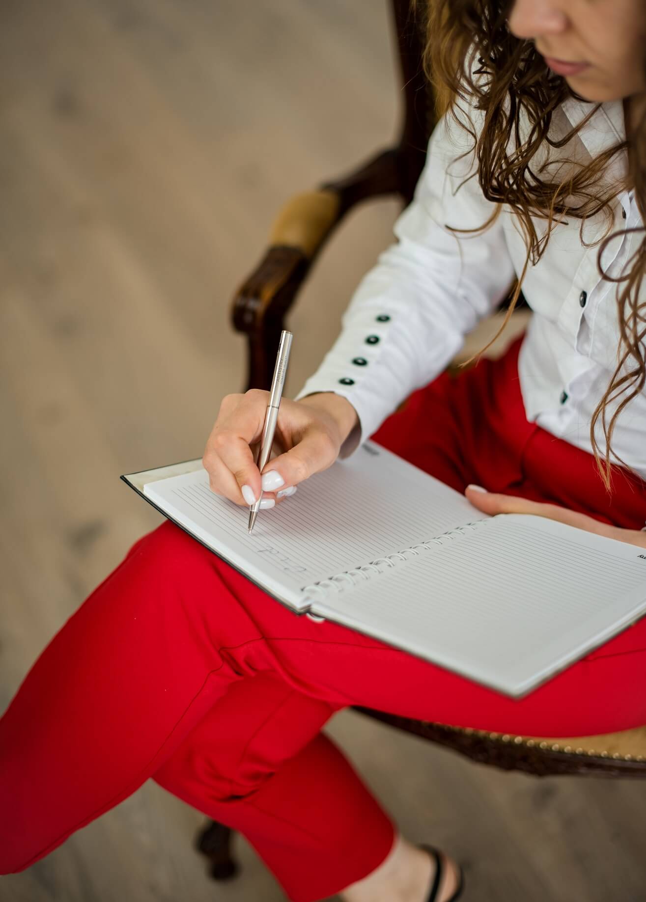 Grow your business with these four areas of commitment woman writing in planner