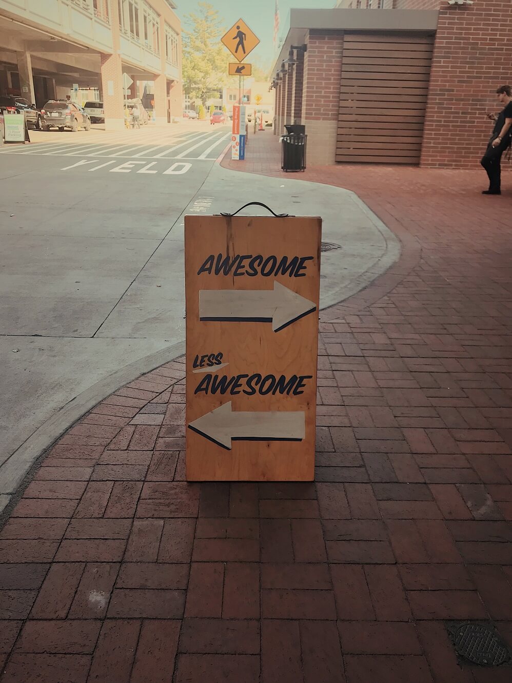 sign that says awesome with pointing arrow and less awesome with arrow pointing in other direction
