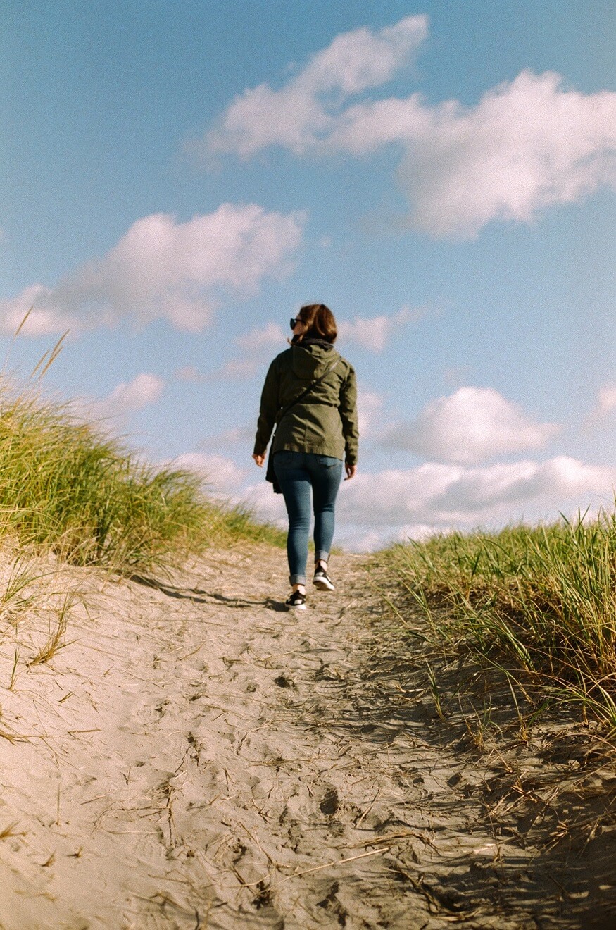 woman climbing up a path