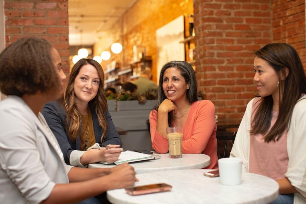 group of women drinking coffee at a business meeting which represents oikos a household of women a Christian entrepreneur community