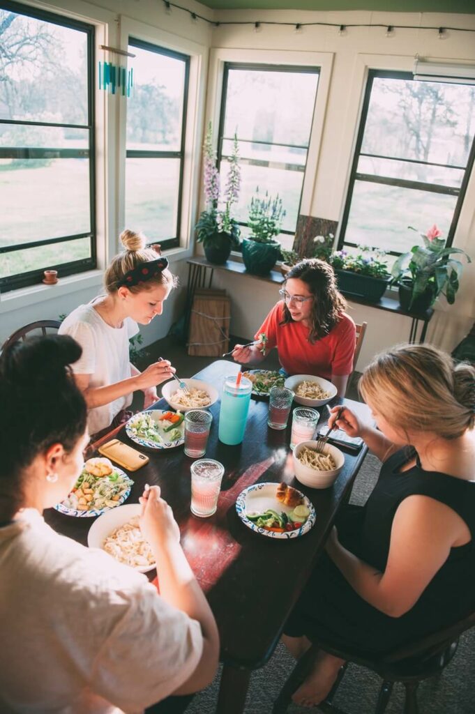 group of women eating dinner to demonstrate oikos a household of women