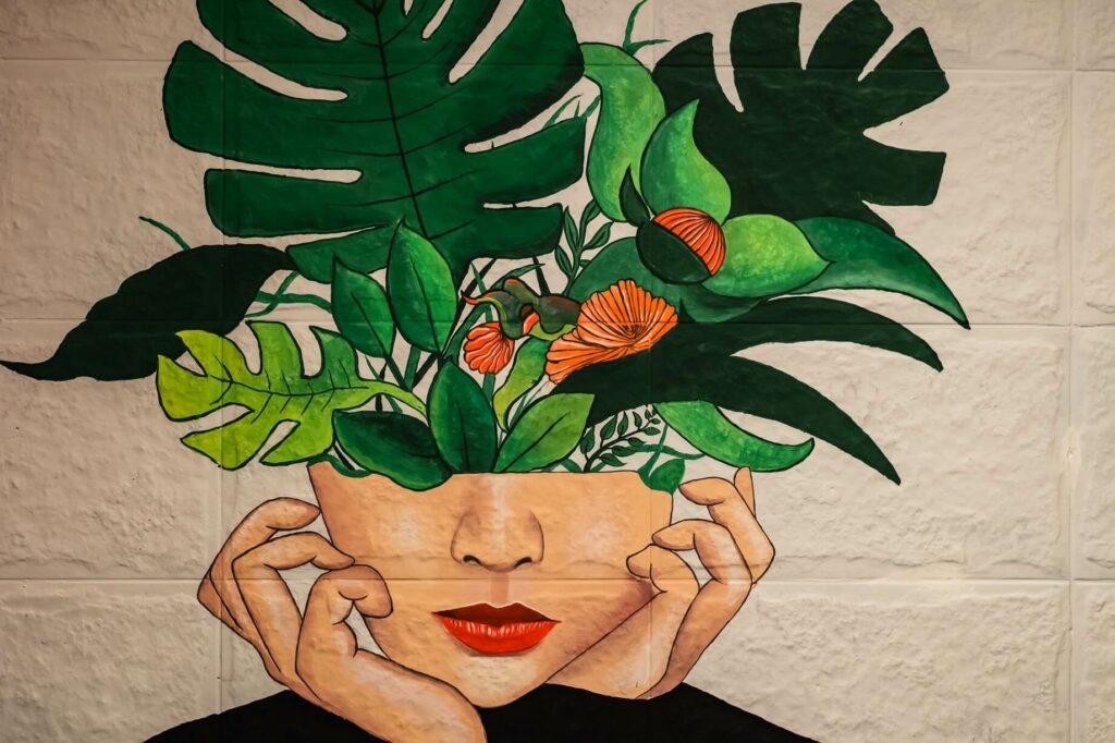 painting of a woman with greenery growing out of her head