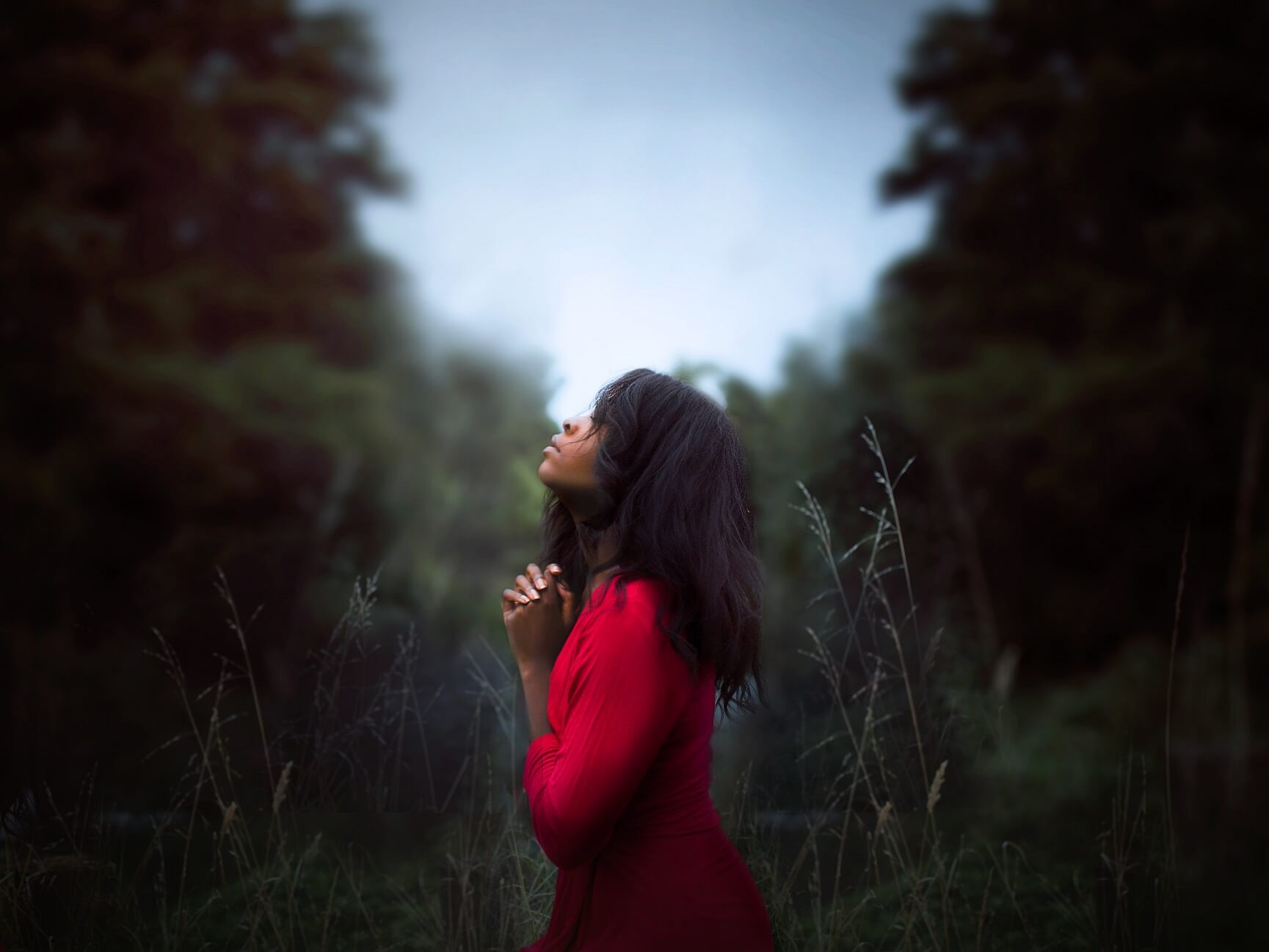 woman praying in trees