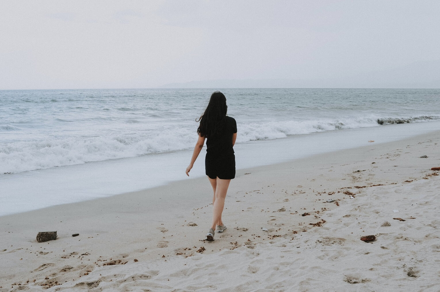 woman walking along the beach