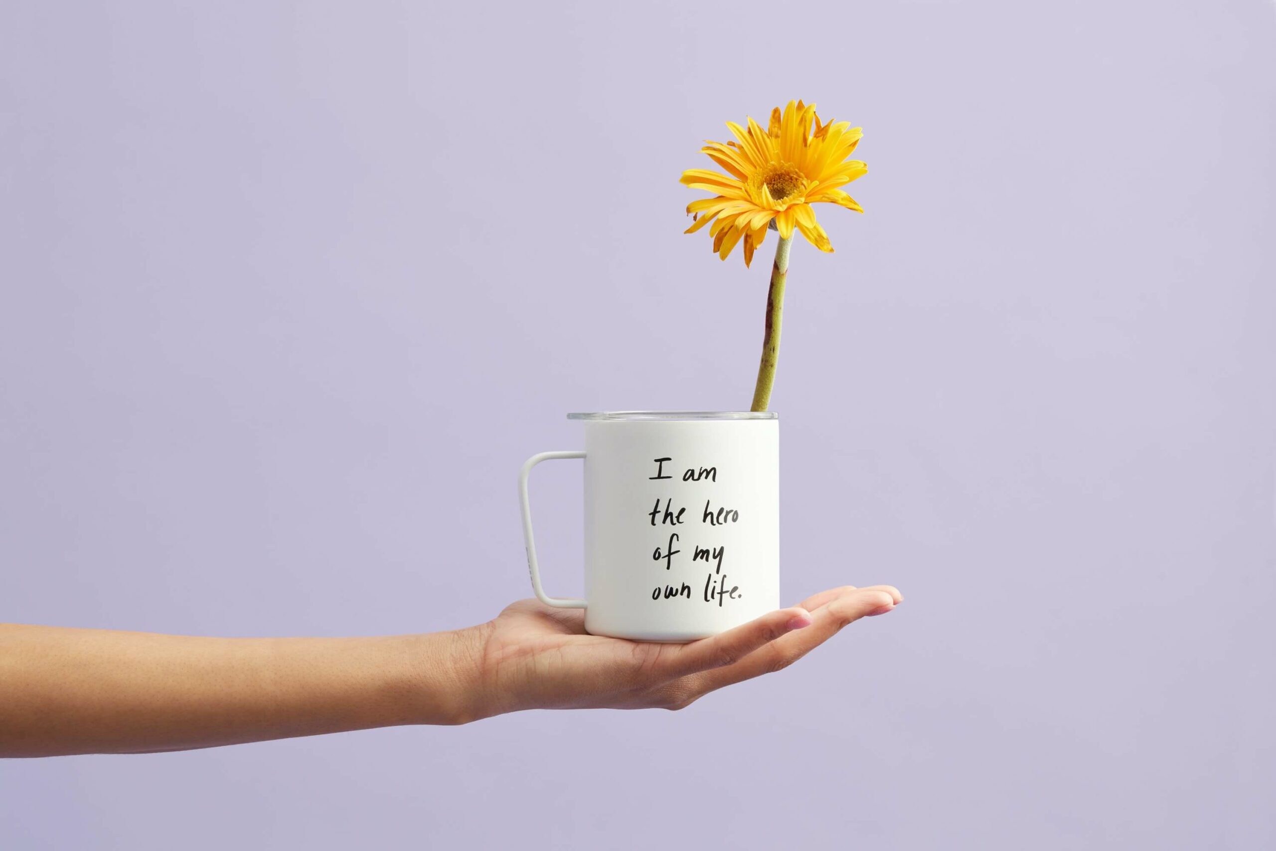woman holding a coffee mug with a flower