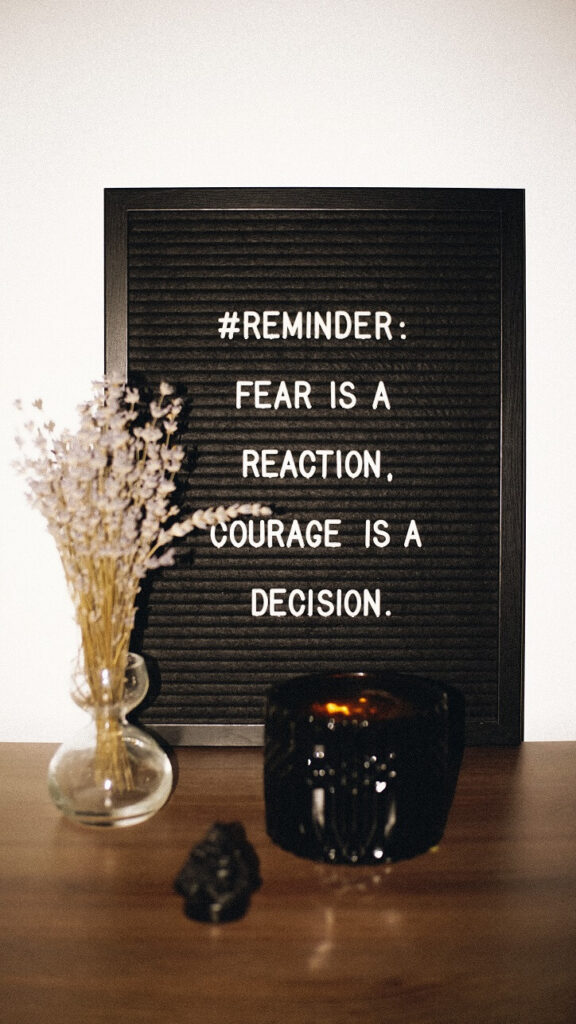 Sign that says "reminder: fear is a reaction, courage is a decision."