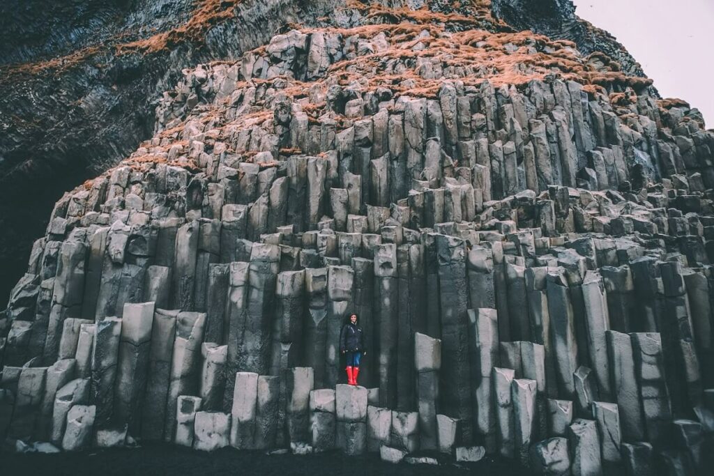 Woman standing out in front of rock formation for a post about risk-taking skills