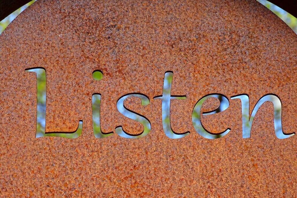 The word listen etched into metal