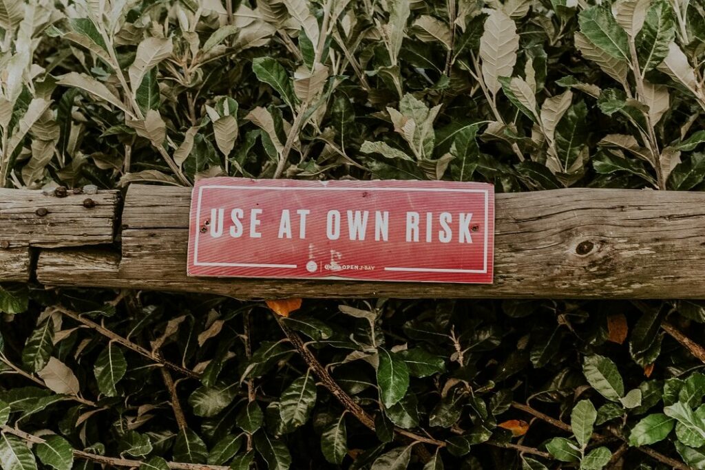 Sign that says use at your risk for a post about risk-taking skills