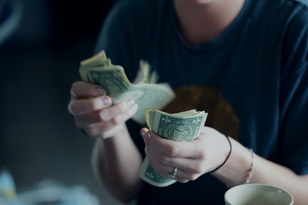 woman counting money to show daily business activities
