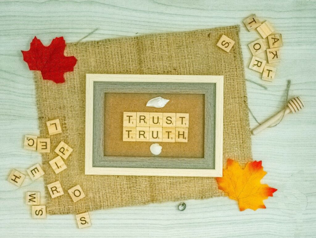 scrabble tiles that spell out trust and truth