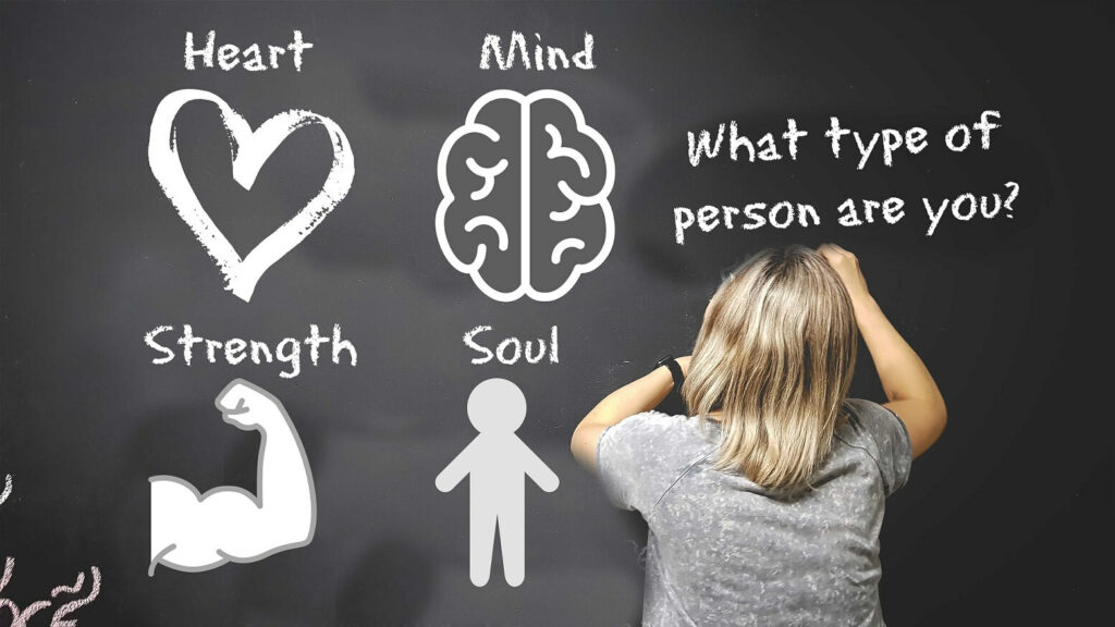 Woman at blackboard that says what type of person are you: heart, mind, strength, soul?