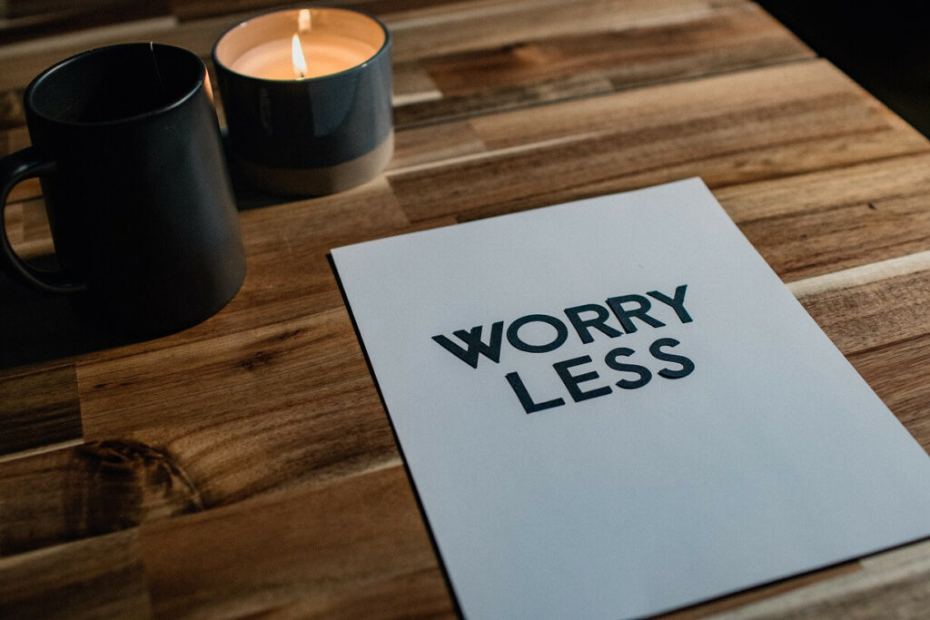 desk with paper that says worry less for blog post on a simple business plan