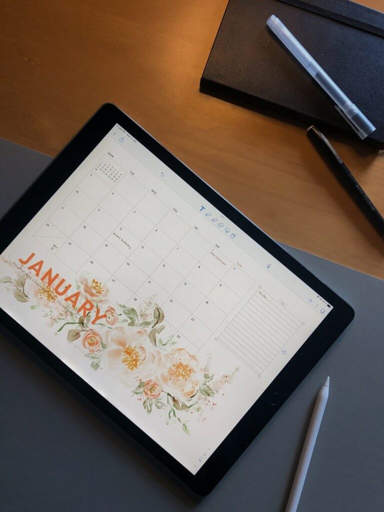 Image of an iPad with the month of January calendar on the screen for the blog post how to plan your business year