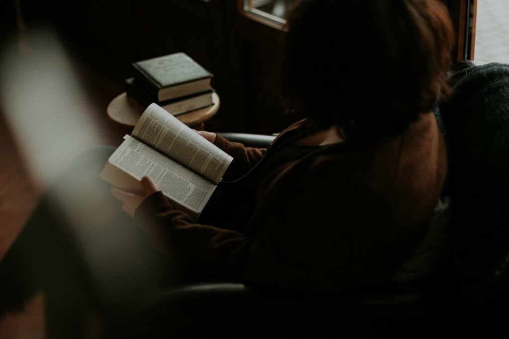 Woman reading the Bible. Used for the blog post to help women get out of the hustle culture and into God's wisdom culture.
