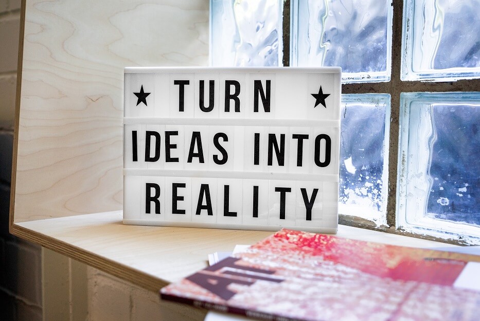 Sign that says turn ideas into reality r for the blog post how to overcome your fears and transition into your own business.