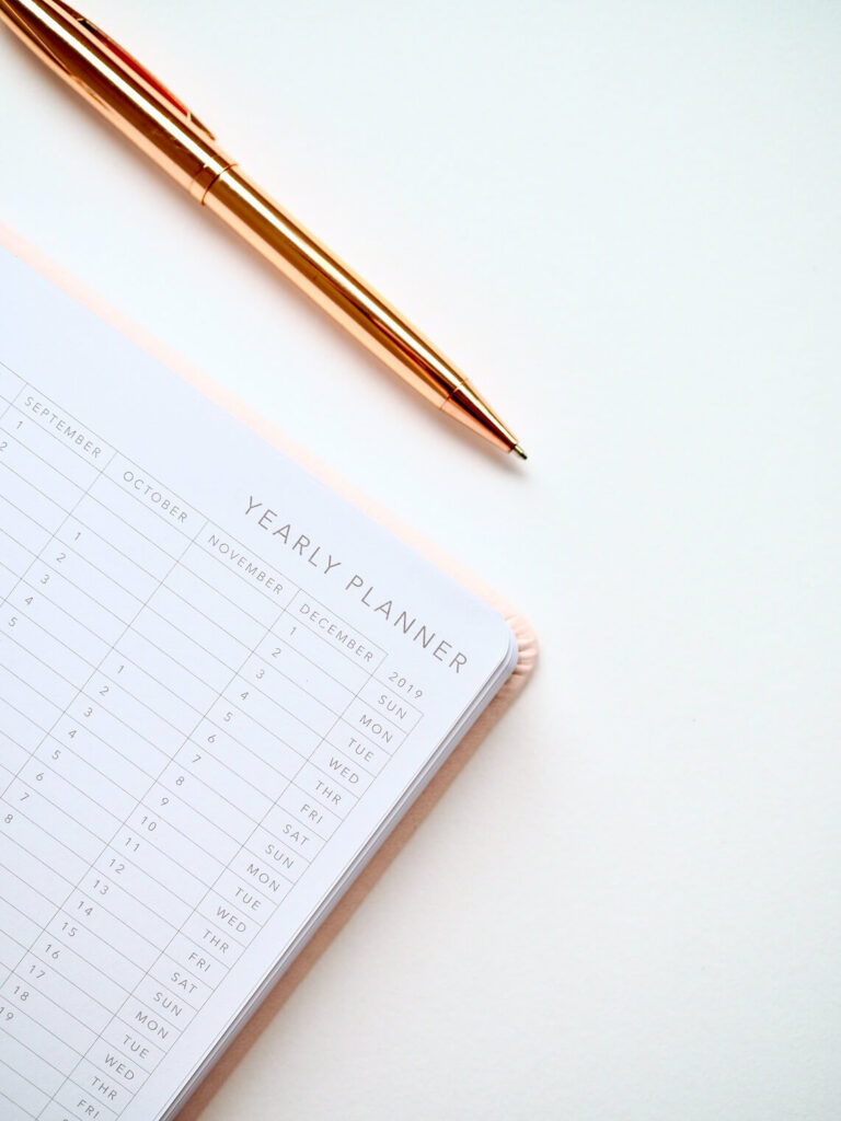Image of a yearly planner with a pen for the blog post how to plan your business year